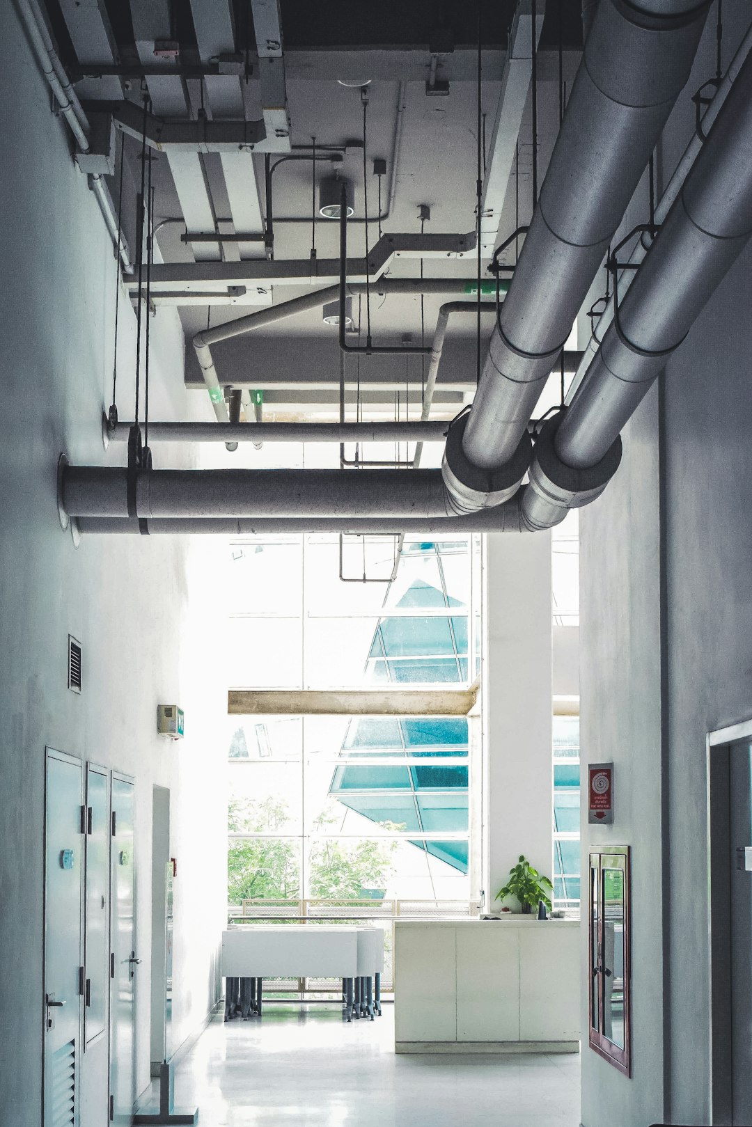 Ventilation ductwork and services running across the ceiling of a commercial building