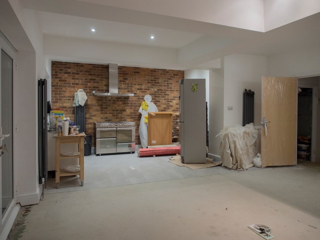 Kitchen refurbishment in progress with appliances staged and exposed brick
