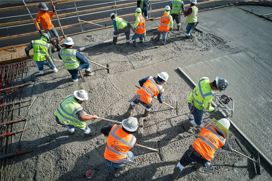 Site team in hi-vis working together on a concrete pour